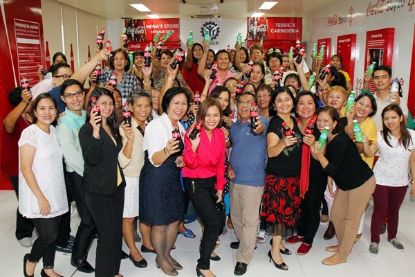 WOMEN REACH! graduates, together with TESDA and Coca-Cola officials, celebrate the conclusion of their 12-week micro-entrepreneurship skills training. At the center are Coca-Cola Sustainability Manager Gilda Maquilan and Labor Undersecretary Nicon Fameronag.